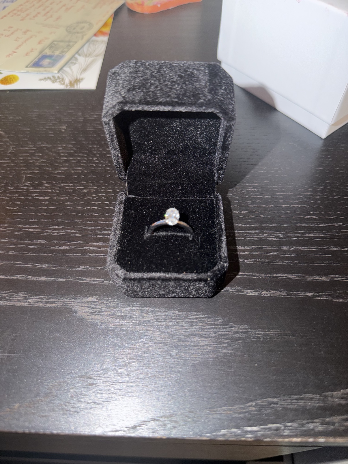 Oval solitaire engagement ring presented in a gift box